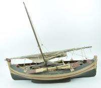 A painted ship's model of a fishing boat with lateen sail,