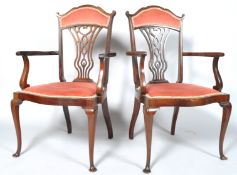 A pair of Edwardian open arm salon chair with upholstered seats and cabriole supports,