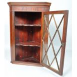 A 19th century mahogany hanging corner cabinet with lattice astragal glazed door,