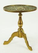 A 19th century brass trivet in the form of a tripod table with baluster stem and pierced top,