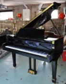 A 20th century baby grand piano with black lacquered finish, iron framed and over-strung,