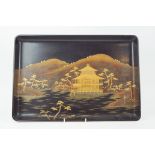 A Japanese lacquer tray, decorated with a pagoda in landscape, with gilt monogram to reverse, 48.