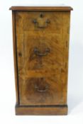 A George III mahogany cross banded side cupboard with three faux drawers opening to reveal two