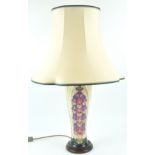 A Moorcroft table lamp, decorated with the foxglove pattern, on wooden base, the vase 36cm high,