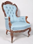 A late 19th century Victorian mahogany button backed armchair being heavily craved ,