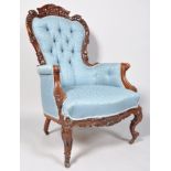A late 19th century Victorian mahogany button backed armchair being heavily craved ,