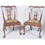 A pair of 19th century mahogany dining chairs with pierced splats,