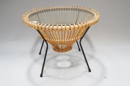 A mid-century wicker, metal and glass coffee table, of drum shaped form, with glass top,