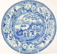 An early 19th century blue and white plate printed with a Chinese scene,