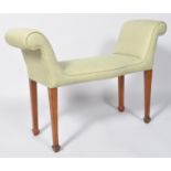 A 20th century stool, the upholstered seat with scroll ends,