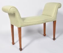 A 20th century stool, the upholstered seat with scroll ends,