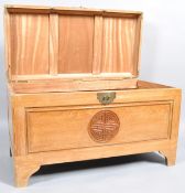 A Chinese camphor wood chest with carved top,