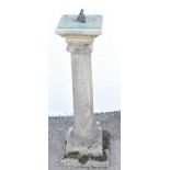 A sun dial, set on a reconstituted stone Corinthian column support,