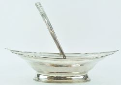 A silver cake basket, of oval form, with ribbed shaped edge terminating in points,