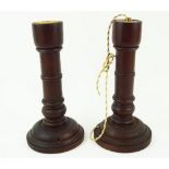 A pair of turned mahogany lamp bases, fitted for electricity, lacking tops, 27.