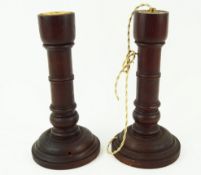 A pair of turned mahogany lamp bases, fitted for electricity, lacking tops, 27.