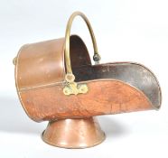 A 19th century copper and brass coal scuttle with swing handle,
