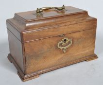 A George III mahogany tea caddy, of rectangular form, with brass swing handle and scroll escutcheon,