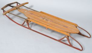 A 1950's children's wood sledge, the 'Flexible Flyer' No 251, overall 127cm long,