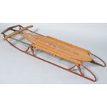 A 1950's children's wood sledge, the 'Flexible Flyer' No 251, overall 127cm long,