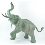 A 20th century bronze figure of an elephant with trunk held aloft,