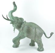 A 20th century bronze figure of an elephant with trunk held aloft,