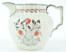 An early 19th century pineapple moulded jug with silver lustre and red enamel decoration,