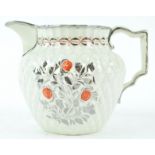 An early 19th century pineapple moulded jug with silver lustre and red enamel decoration,