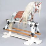 A 20th century carved wood and painted rocking horse with white horse hair mane and tail,