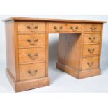 A Victorian oak knee hole desk with leather inset top above three frieze drawers and three drawers