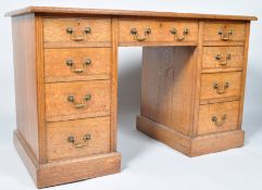 A Victorian oak knee hole desk with leather inset top above three frieze drawers and three drawers