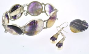 A collection of blue john jewellery to include: A seven domed panel bracelet;