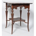 An Edwardian mahogany shaped occasional table, the turned tapering legs linked by an under-shelf,