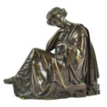 A 19th century bronze figure of a lady seated, wearing classical costume,