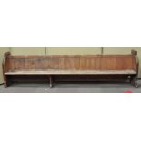 A Victorian pine pew, both ends carved with a quatrefoil,