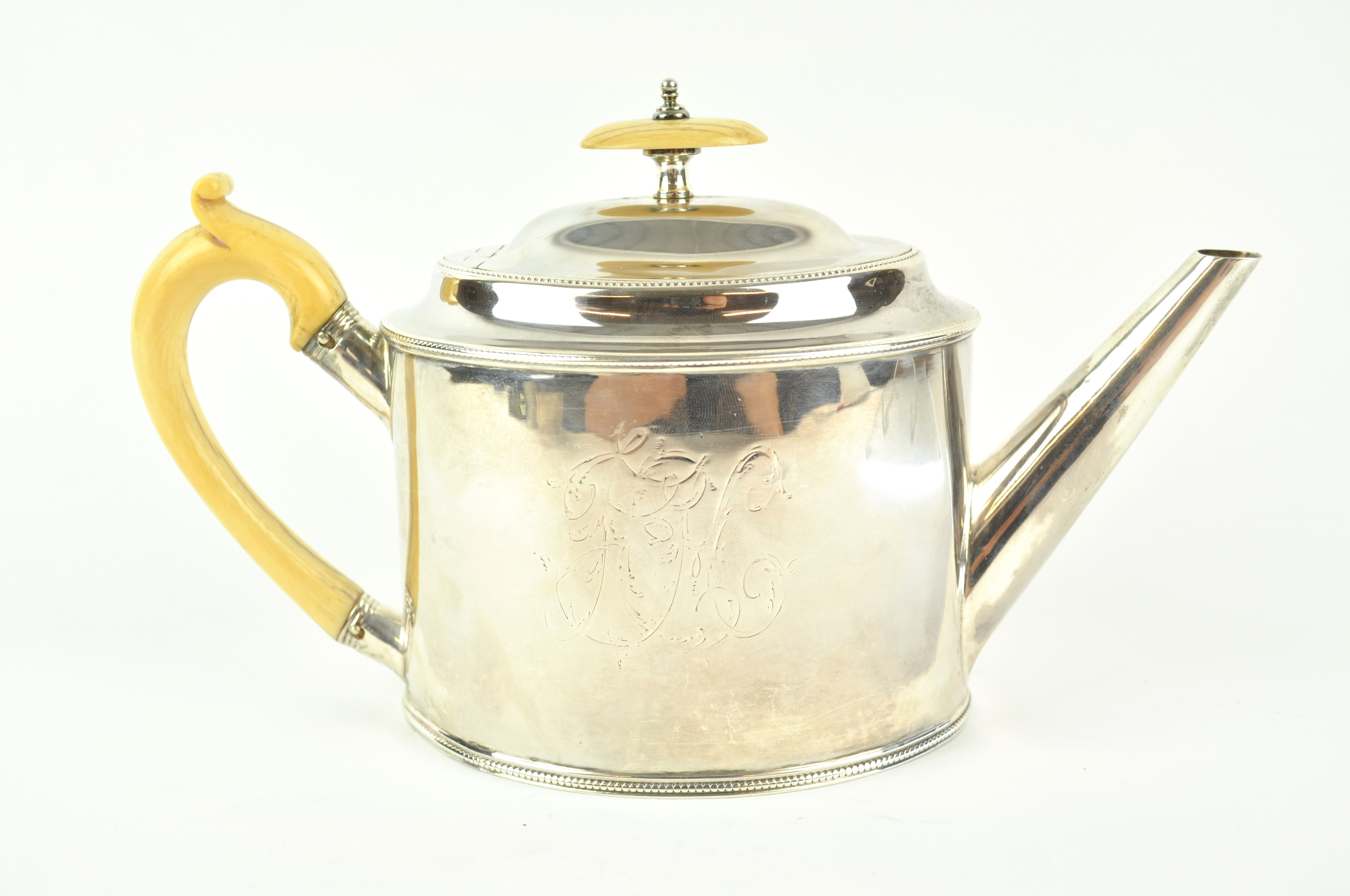 A George III silver tea pot, of plain oval bead edge form, with domed cover, Ivory knop and handle,