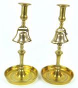 A pair of brass Tavern candlesticks, each mounted with a bell,