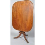 A 19th century mahogany tilt top table, the rectangular top on turned pedestal,