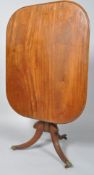 A 19th century mahogany tilt top table, the rectangular top on turned pedestal,