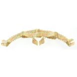 A three colour gold brick link jewellery set consisting of a necklet,