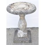 A reconstituted stone bird bath,