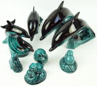 A group of Poole pottery animals, comprising a pair of large leaping dolphins atop waves,