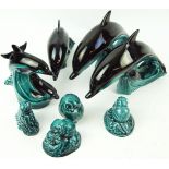 A group of Poole pottery animals, comprising a pair of large leaping dolphins atop waves,