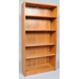 A 20th century retro vintage teak wood bookcase, having four shelves, all raised on a plinth base,