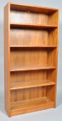 A 20th century retro vintage teak wood bookcase, having four shelves, all raised on a plinth base,