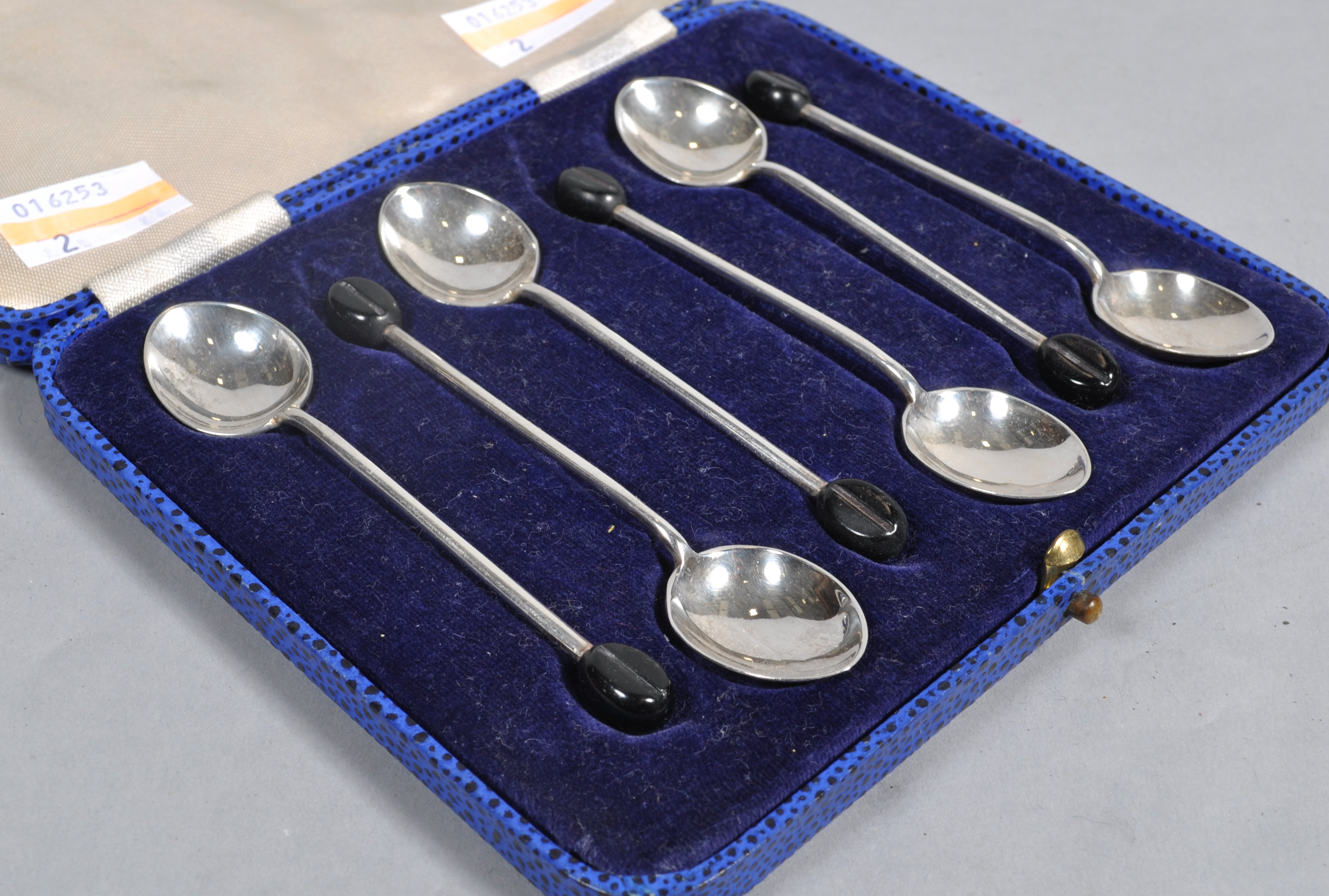 A cased set of silver coffee spoons with coffee bean terminals, by Walker & Hall, Sheffield 1937,