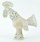 A Studio pottery figure of a cockerel with pierced decoration to the head, neck, wings and tail,