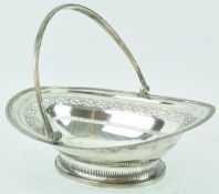 A Sheffield plate cake basket, of oval form with a ribbed swing handle and ribbed edge,