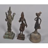 Three Asian Buddhistic bronze deities, two on plinth bases, one a bell, 18.