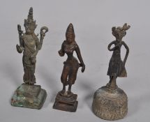 Three Asian Buddhistic bronze deities, two on plinth bases, one a bell, 18.